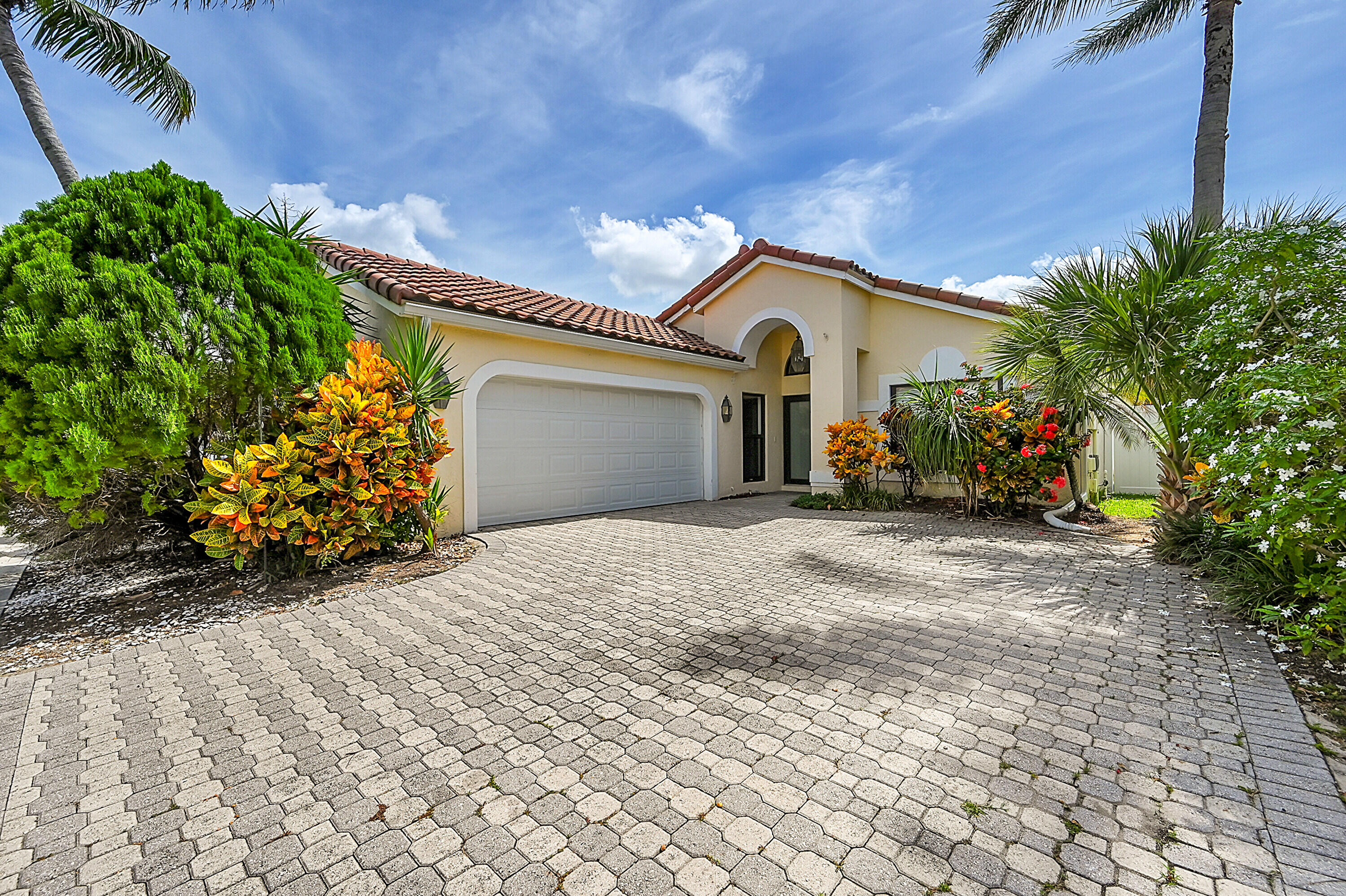 a view of a house with a yard and a garage