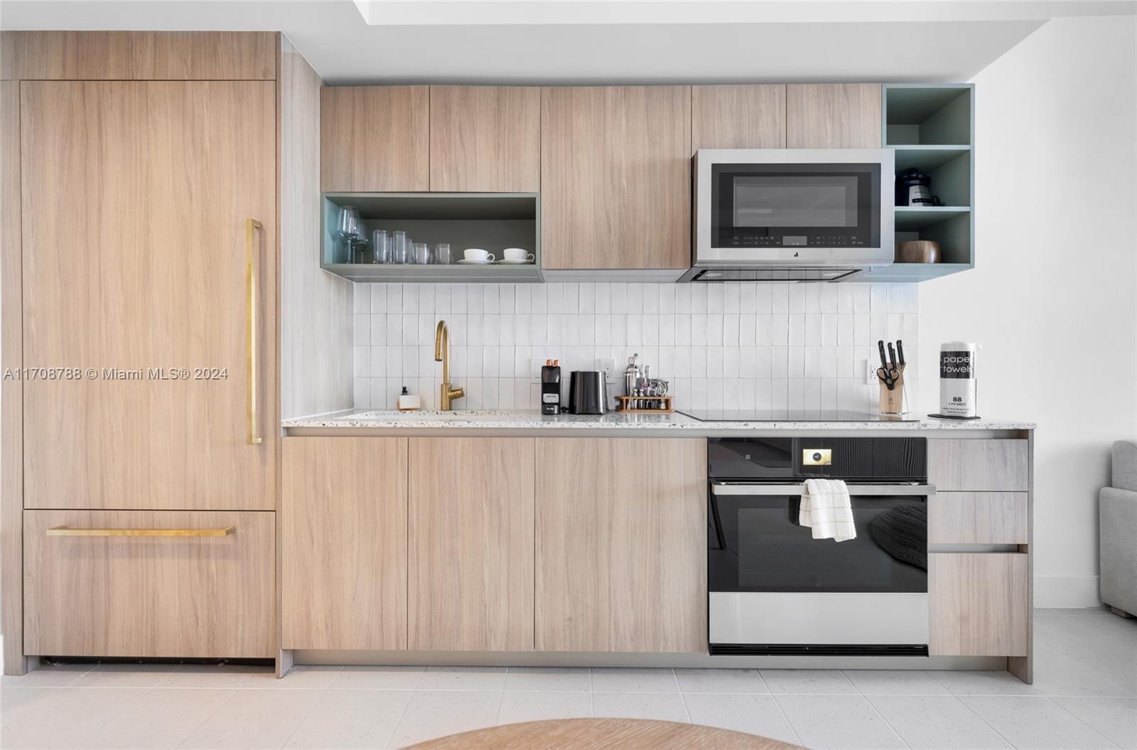 a kitchen with stainless steel appliances granite countertop a refrigerator and a stove top oven