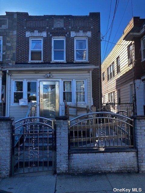 a view of a brick house with many windows