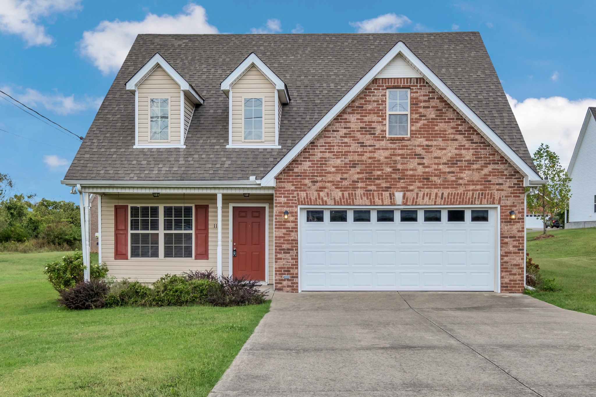 a front view of a house with a yard