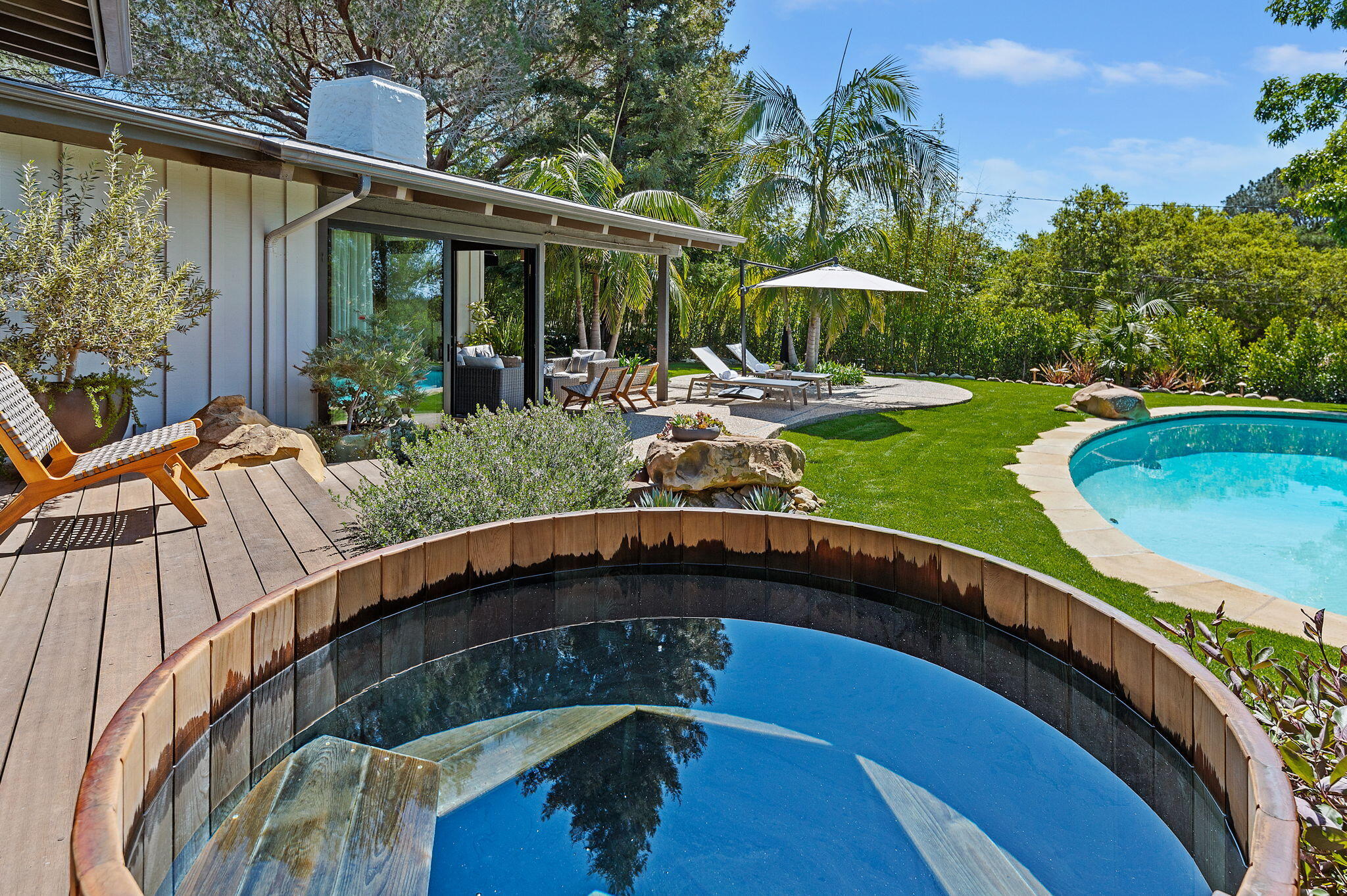 a view of swimming pool with outdoor seating and plants