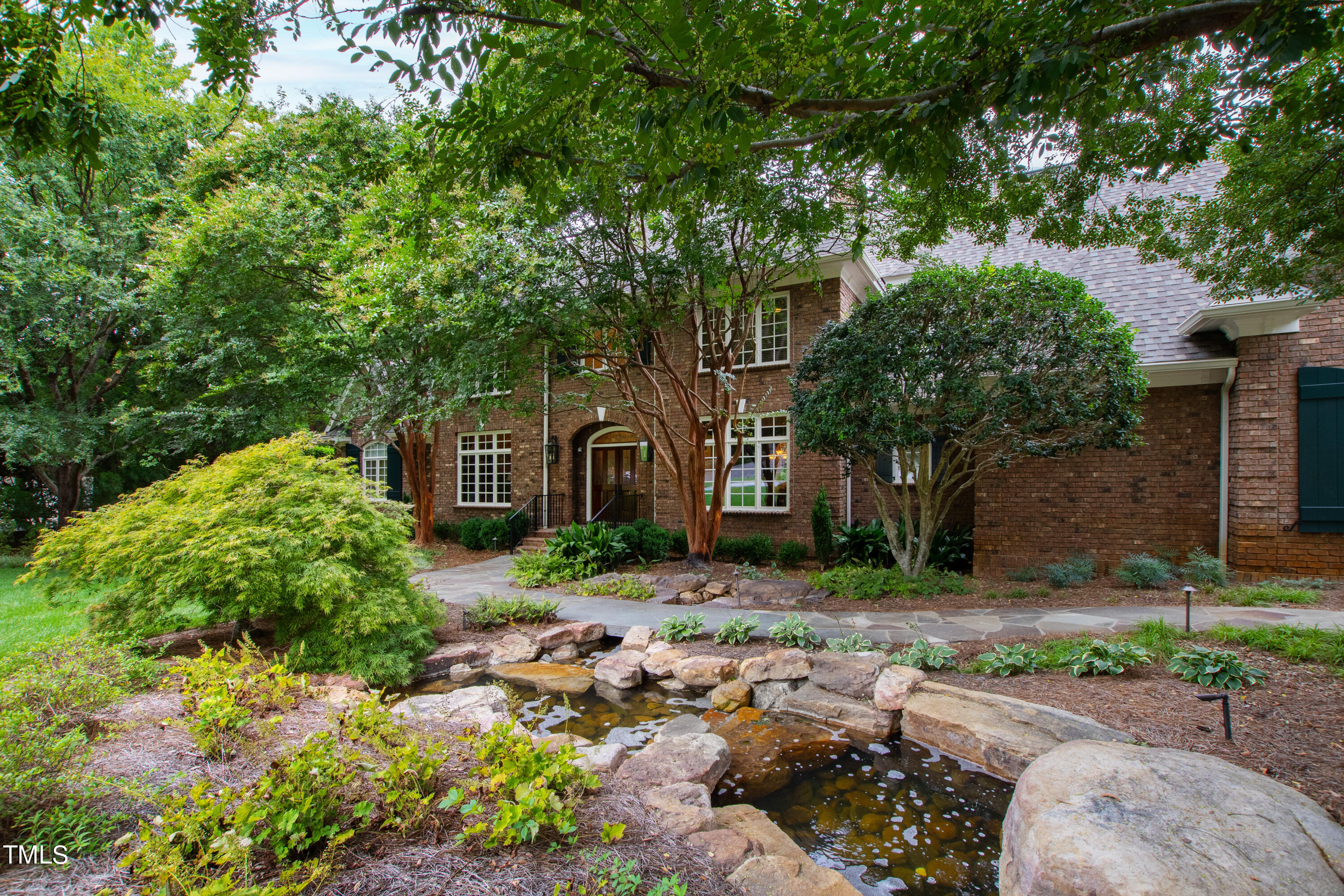 a front view of a house with garden