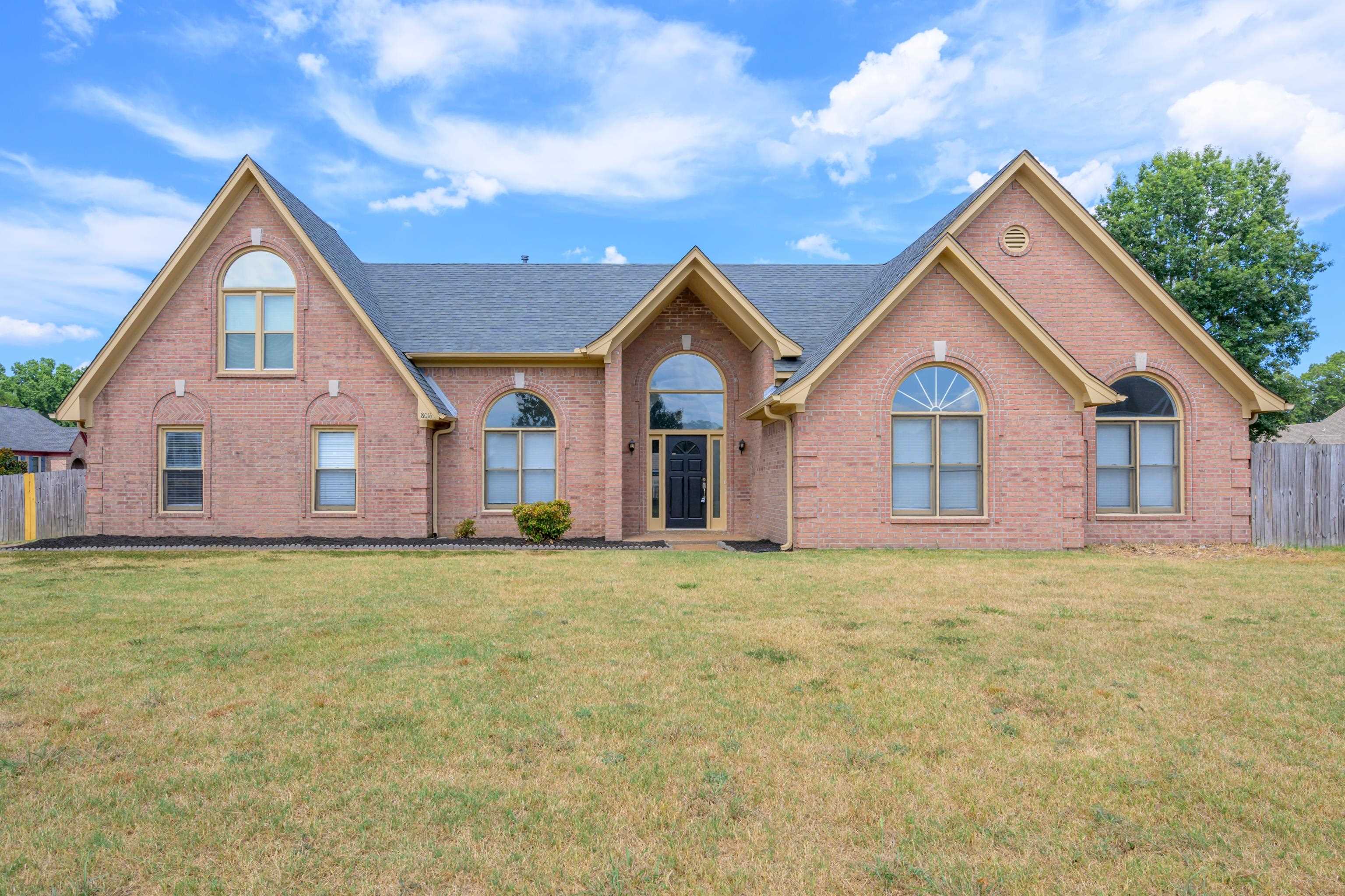 a view of a house with a yard