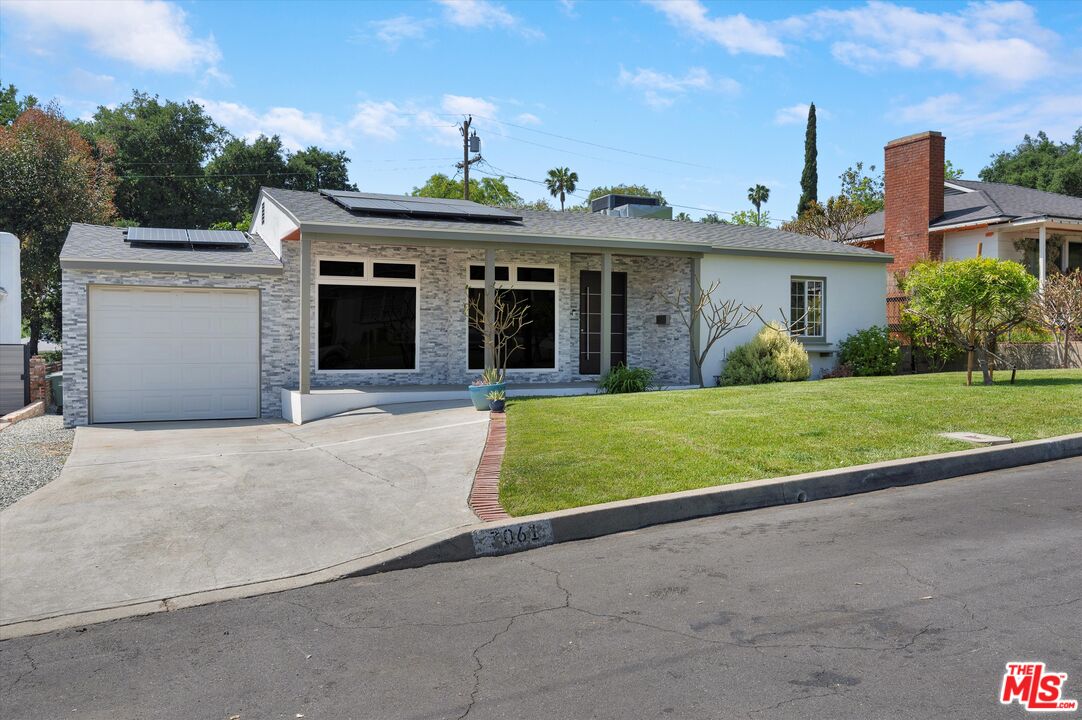 a view of a house with a yard and plants