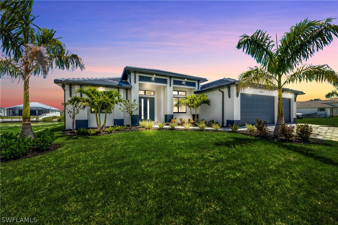 a backyard of a house with table and chairs plants and palm tree