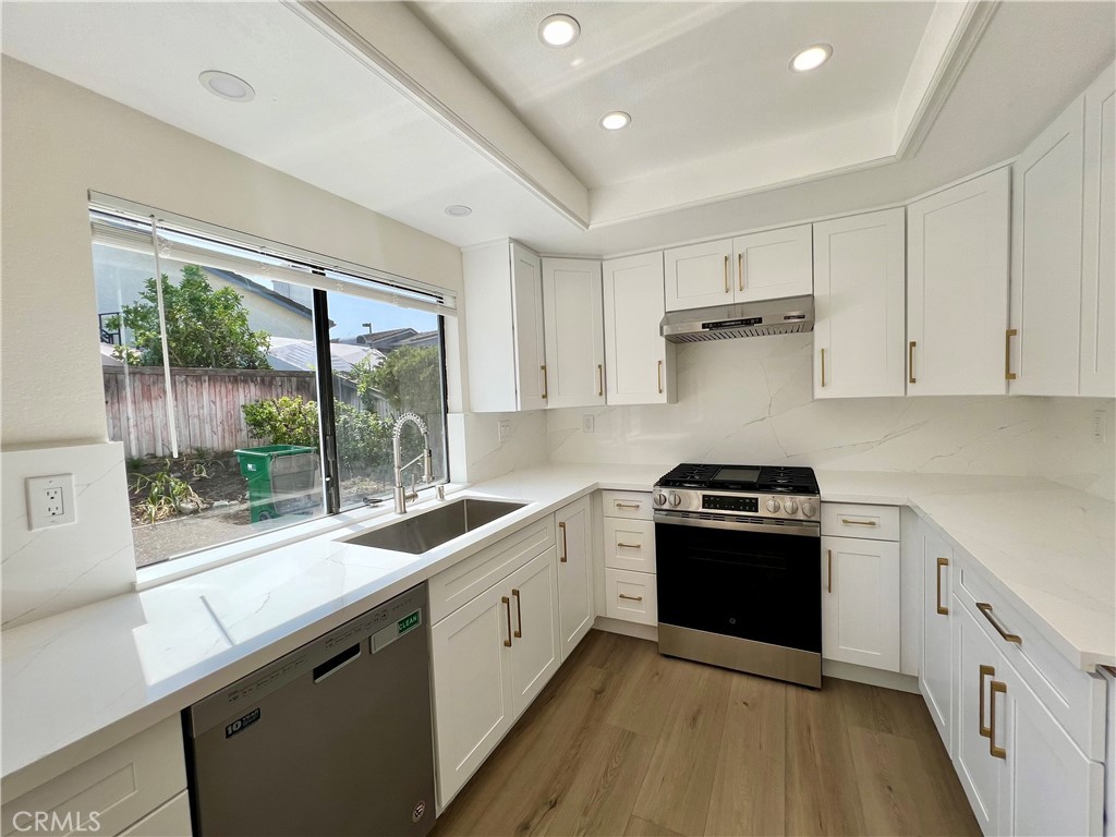 a kitchen with a sink stove and refrigerator