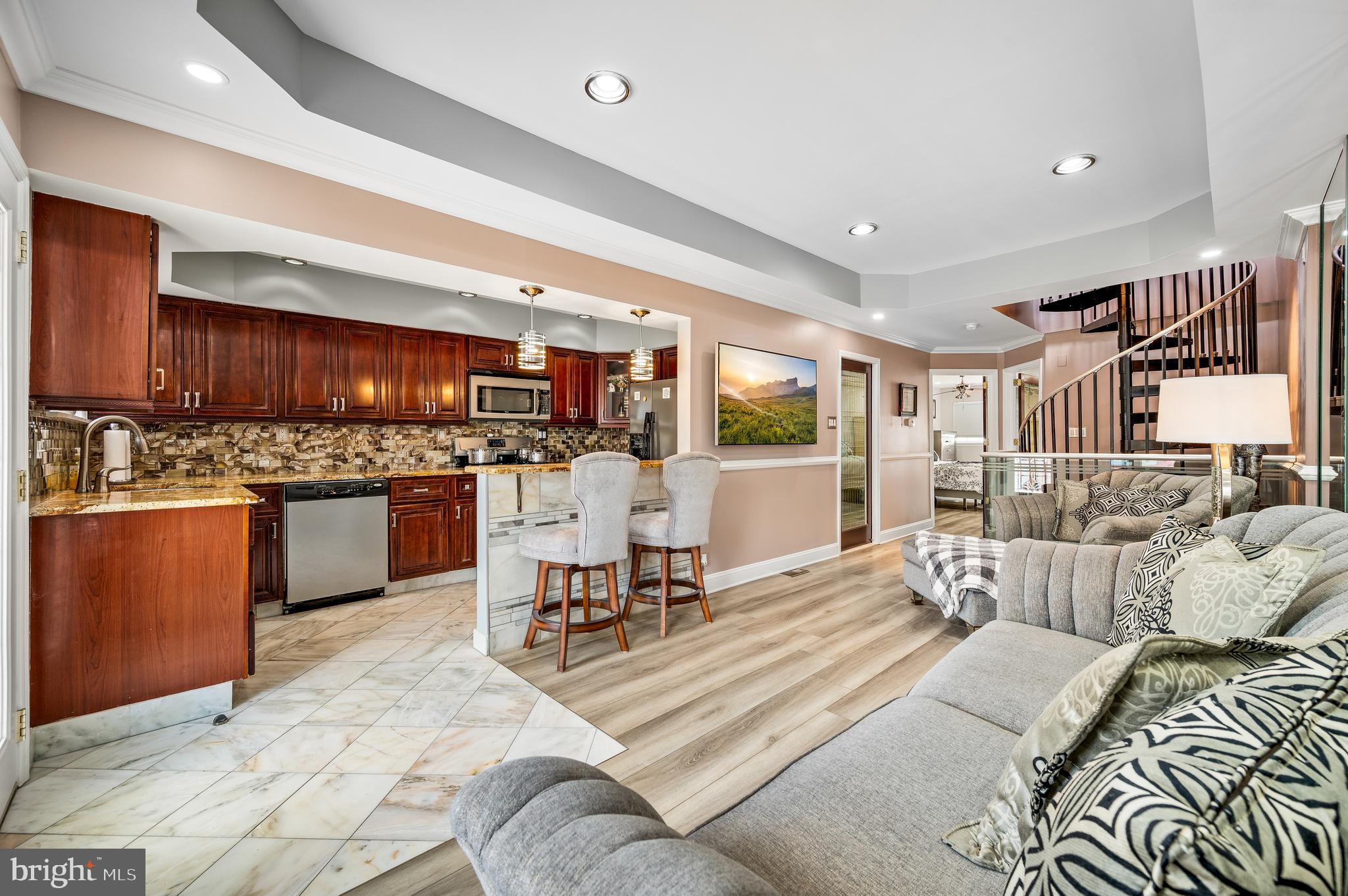 a living room with furniture appliances and a kitchen view