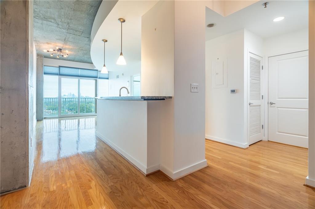 a view of a room with wooden floor and cabinet