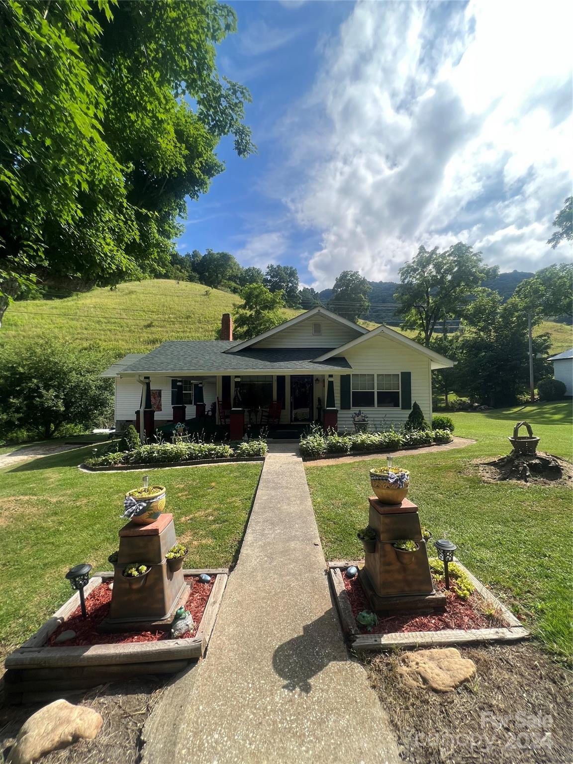 a front view of a house with garden