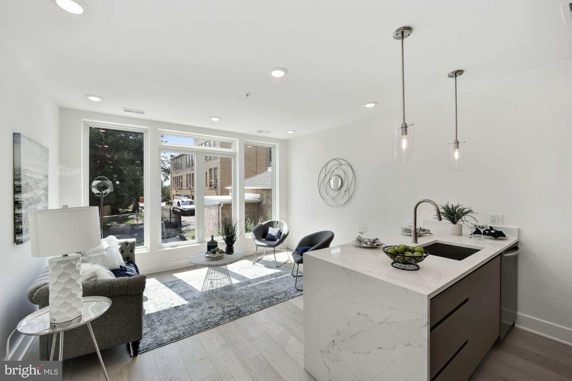 a room with furniture a rug and white walls