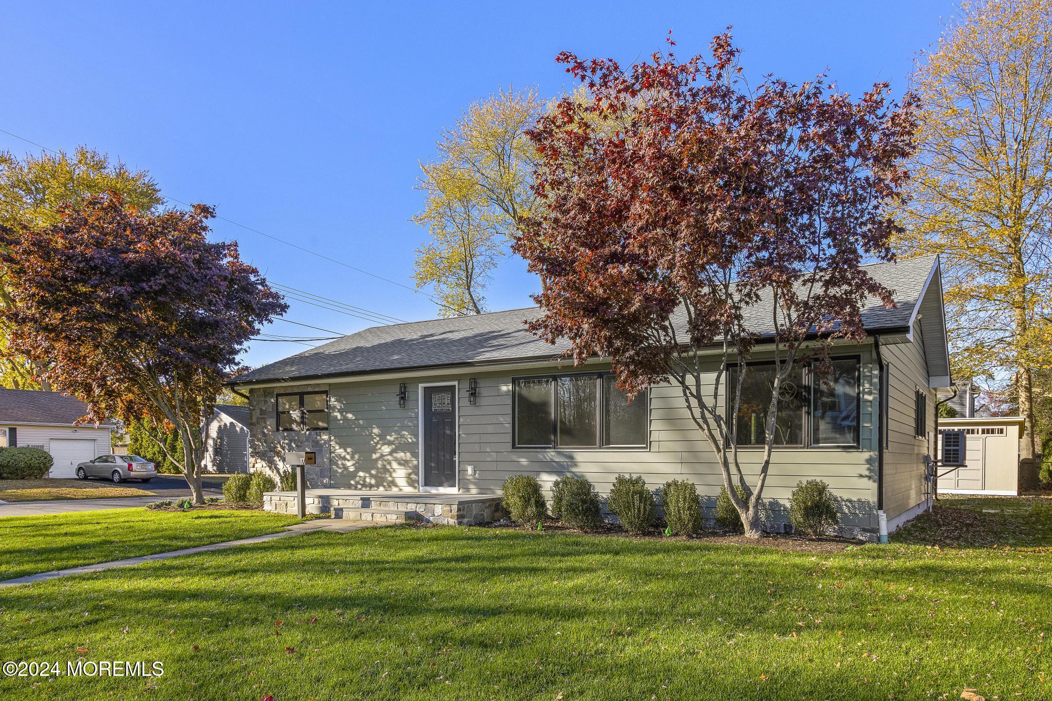 a front view of a house with a garden