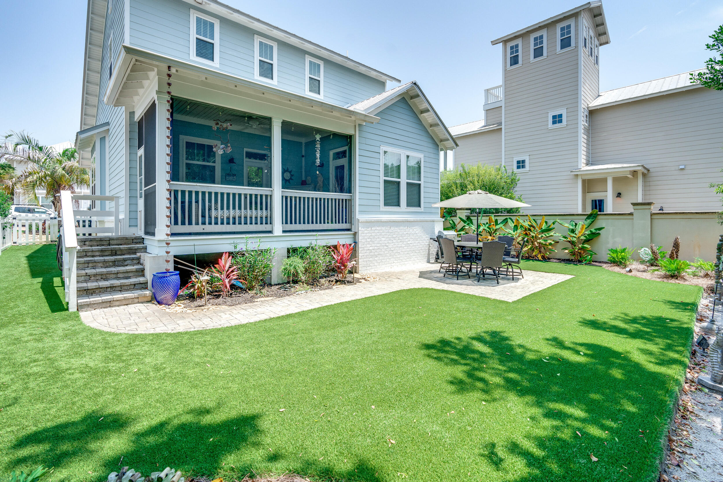 a front view of a house with sitting area and garden