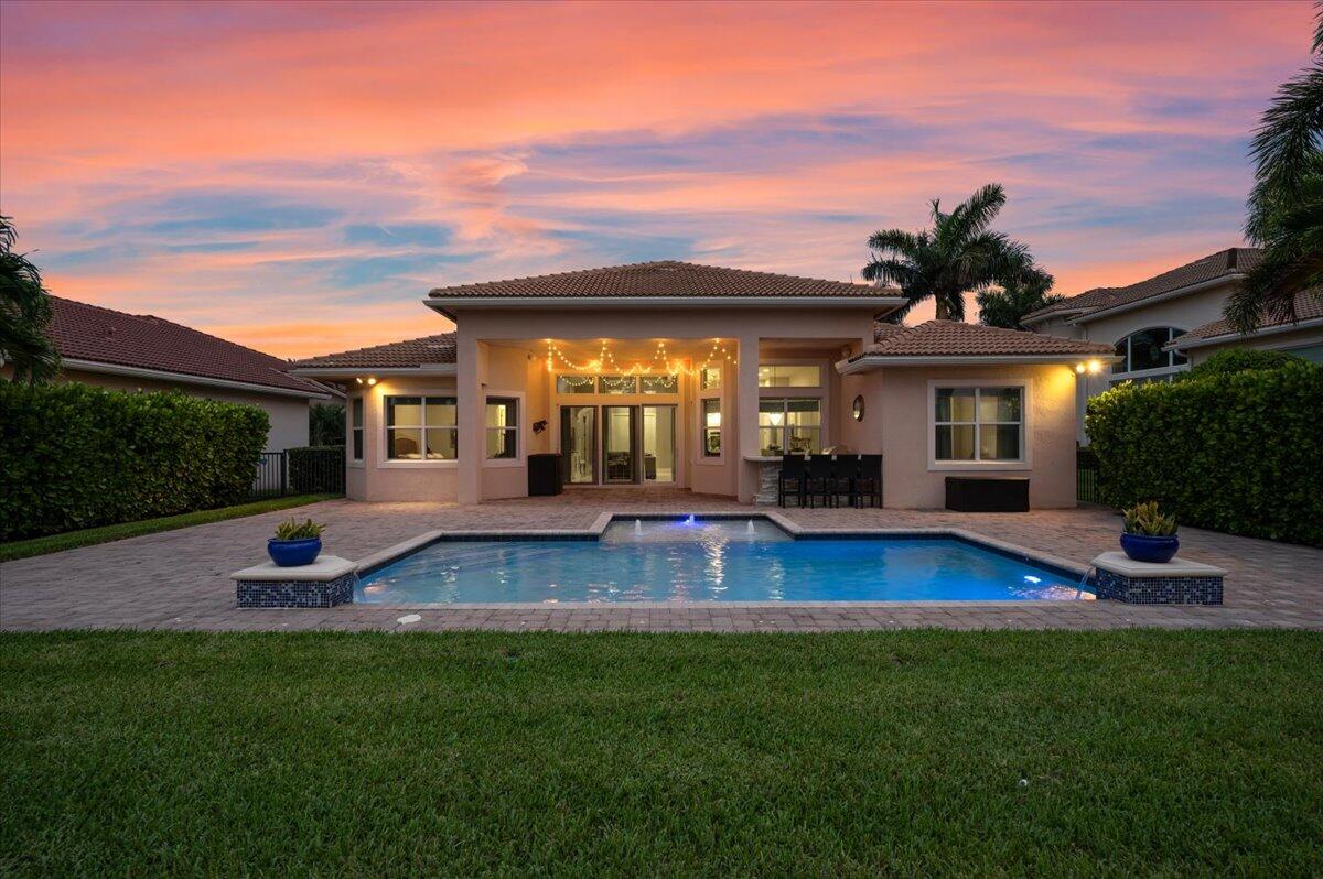 a view of house with swimming pool yard fire pit and outdoor seating