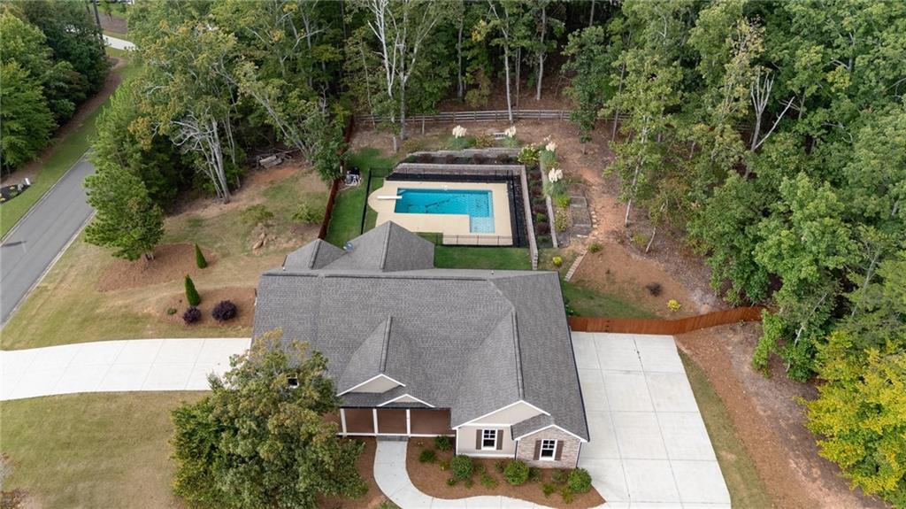 an aerial view of a house with swimming pool