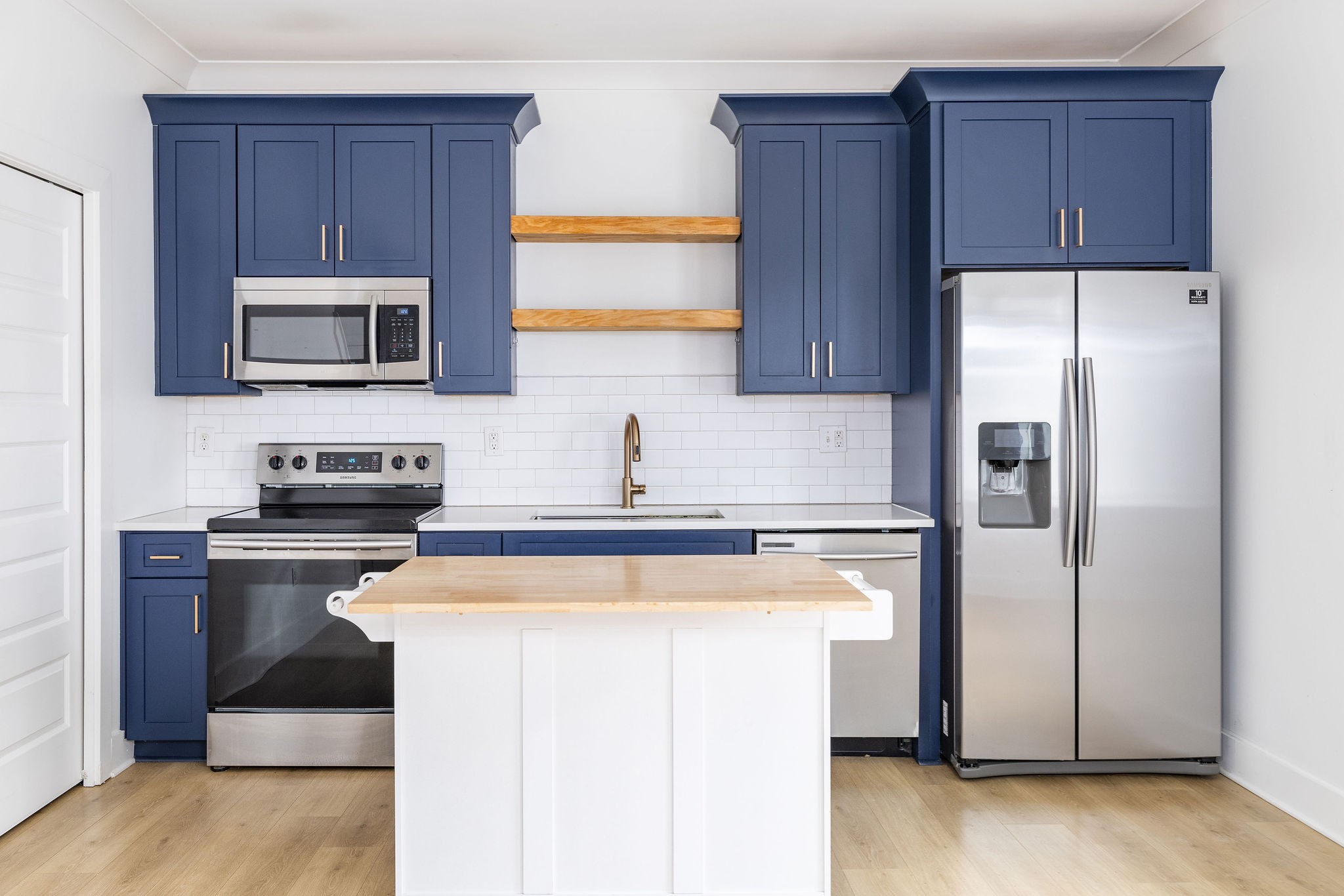 a kitchen with a refrigerator sink and microwave