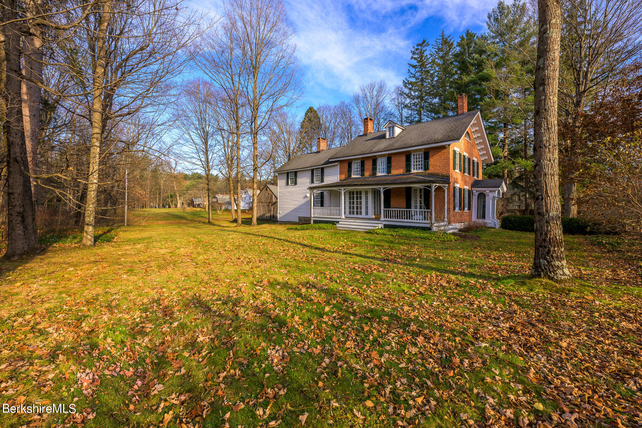 a view of a house with a yard covered with snow