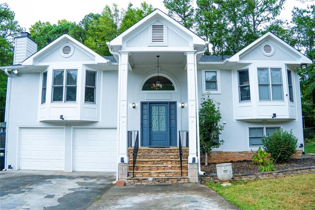 a front view of a house with a yard and garage