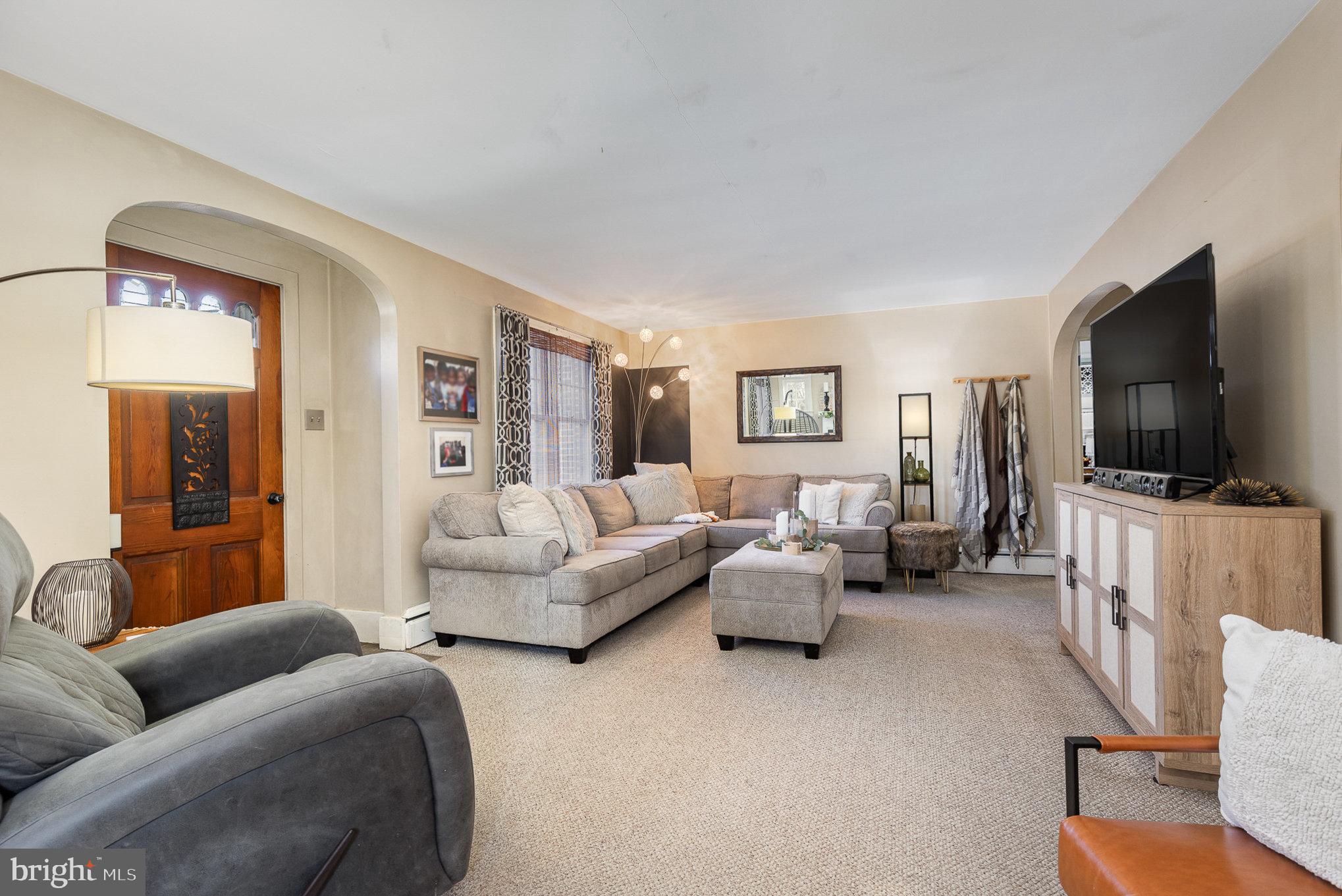 a living room with furniture and a flat screen tv