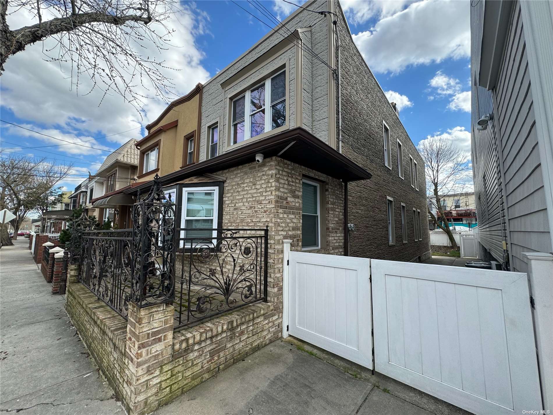 a view of a house with a wooden fence