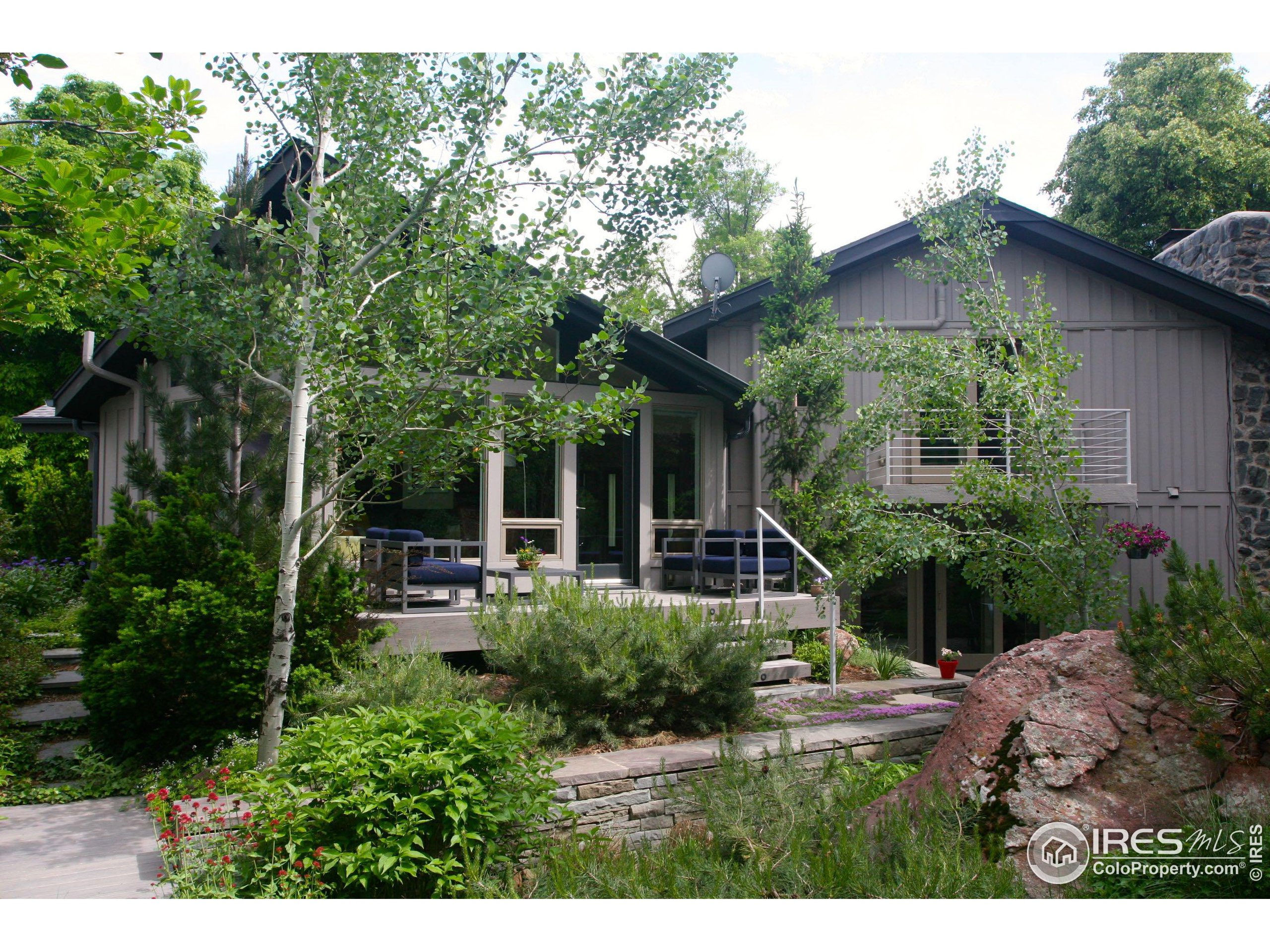 a view of house with backyard and outdoor seating