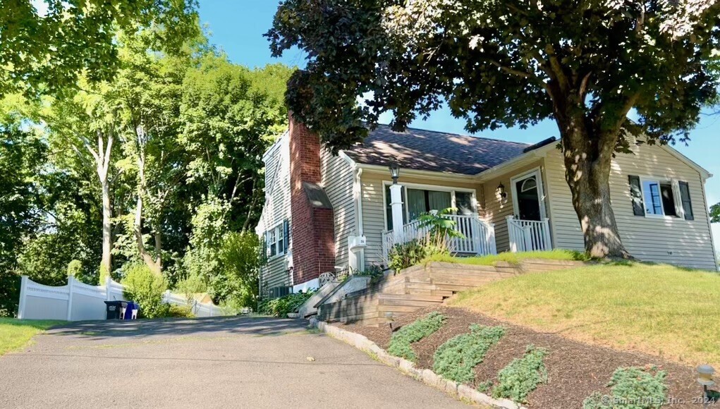 a front view of a house with a garden and plants