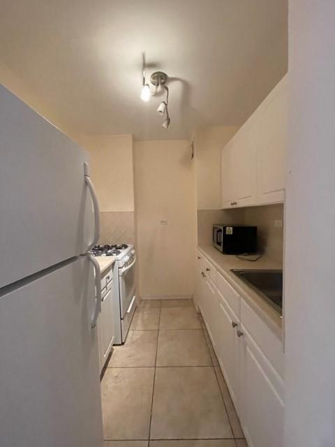 a kitchen with a cabinets and white appliances