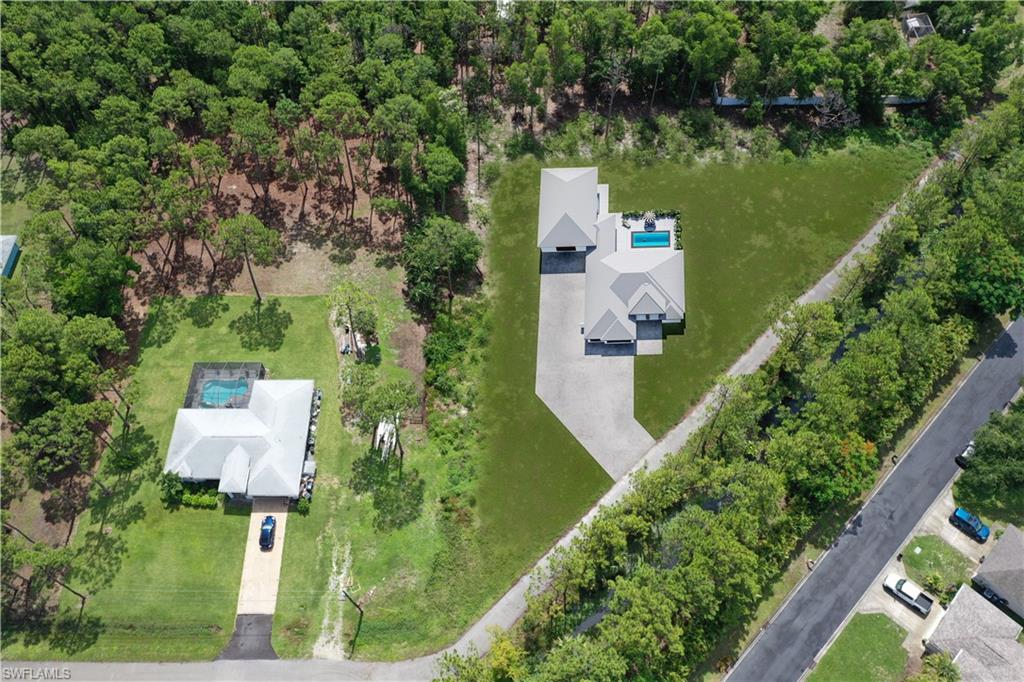 an aerial view of a house with a yard and lake view