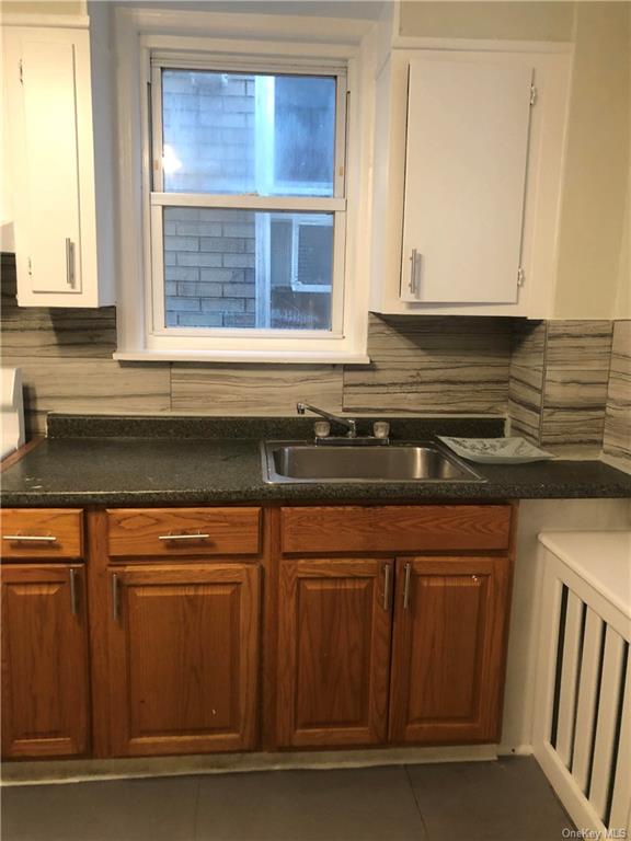 a kitchen with granite countertop a stove and a sink