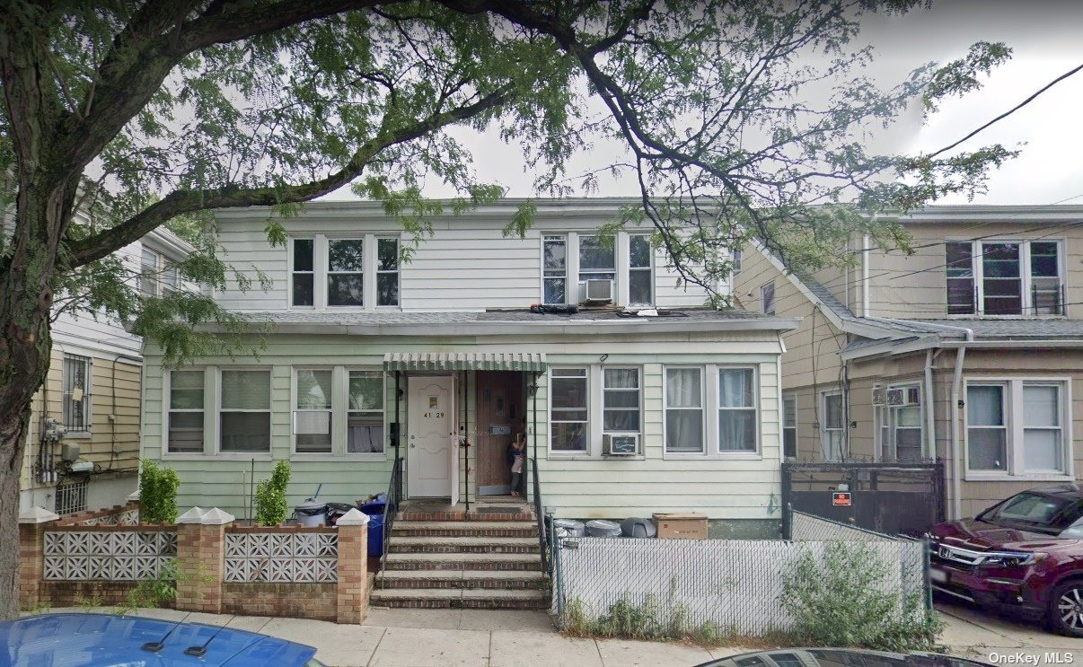 front view of a house with a tree