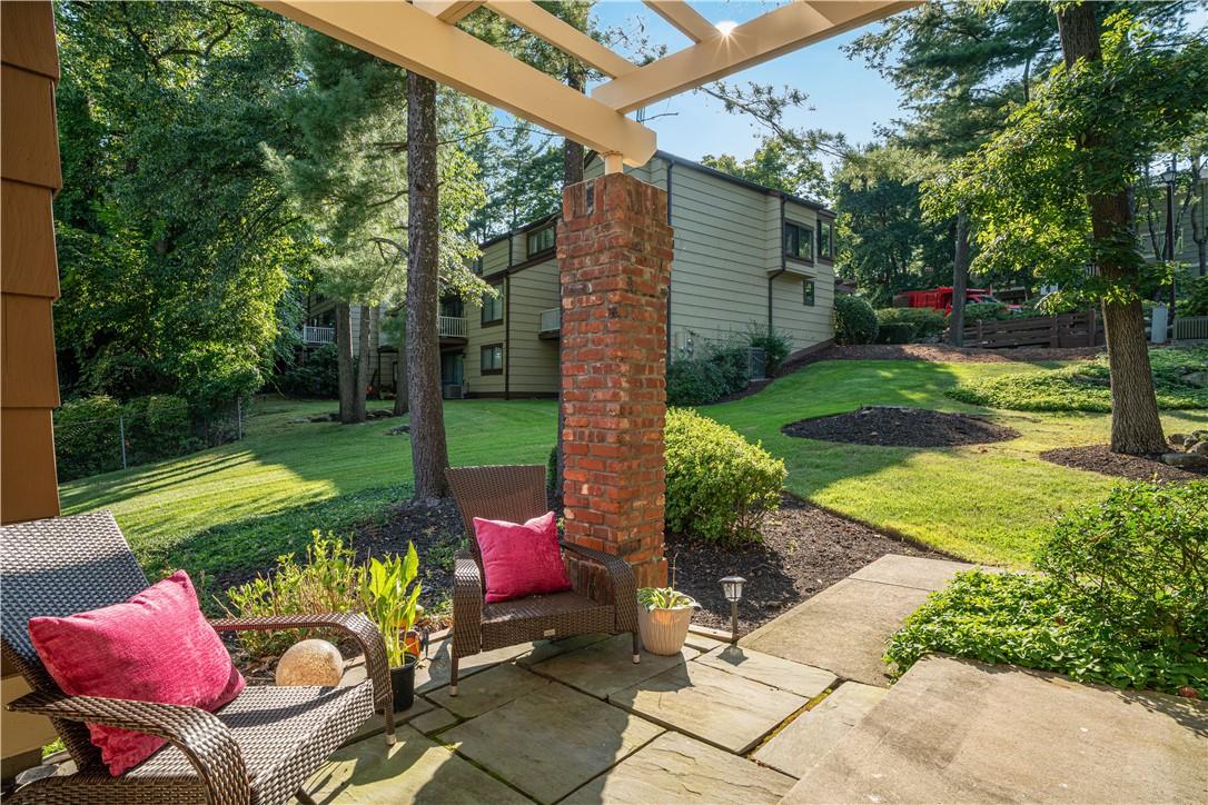 a view of backyard with seating space and trees