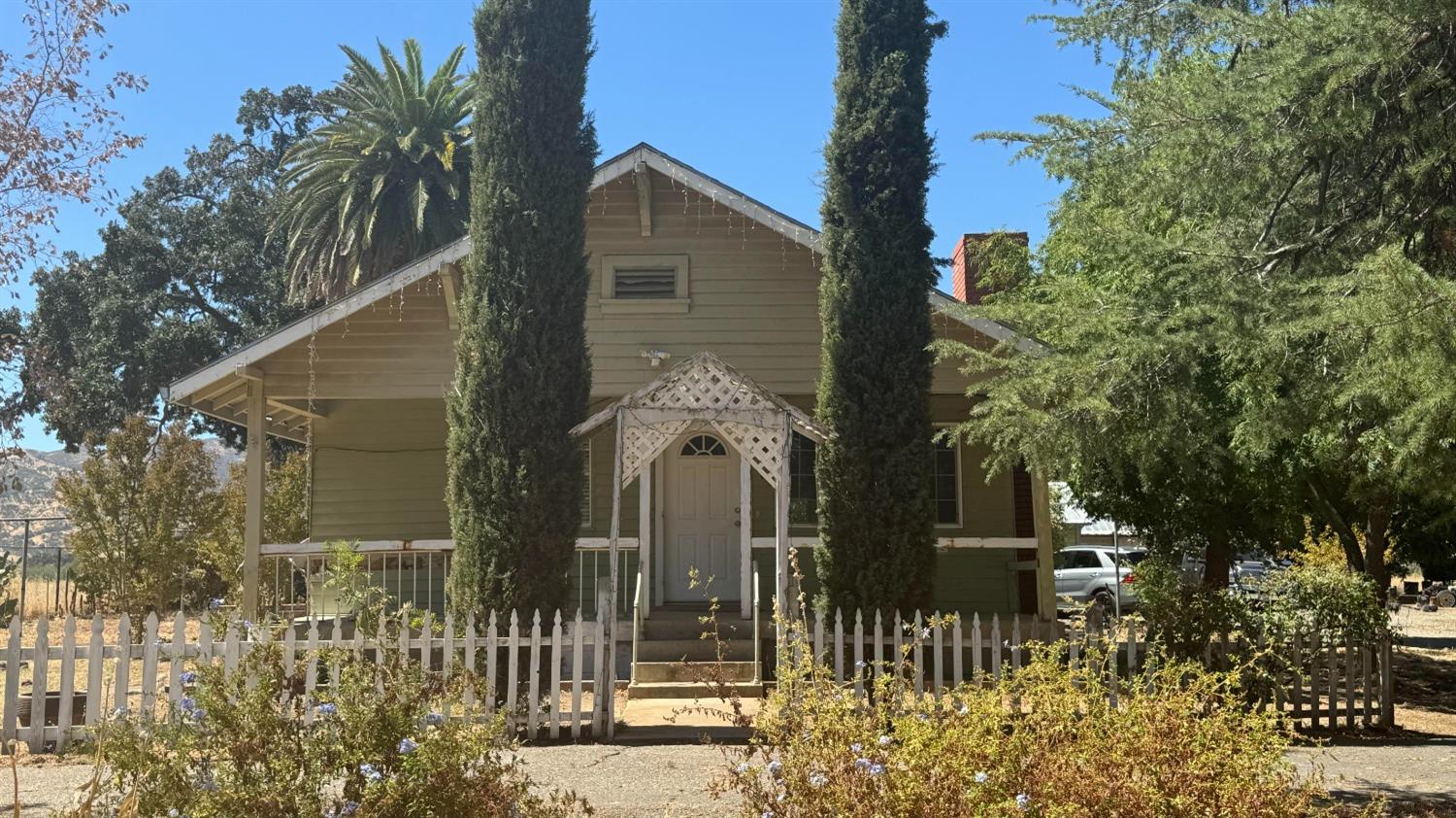 a front view of a house with a garden