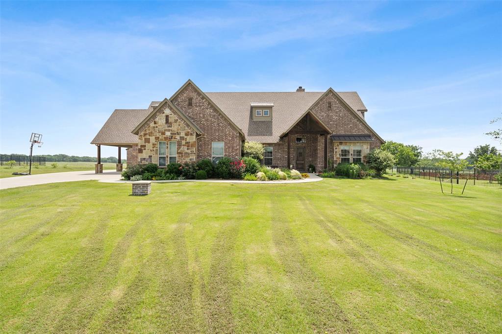 a front view of house with yard and swimming pool