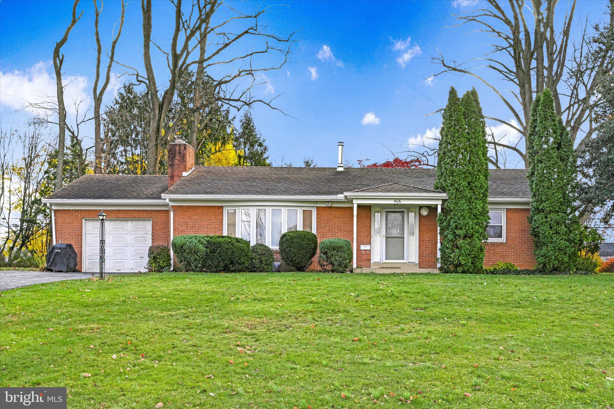 a front view of house with yard and green space