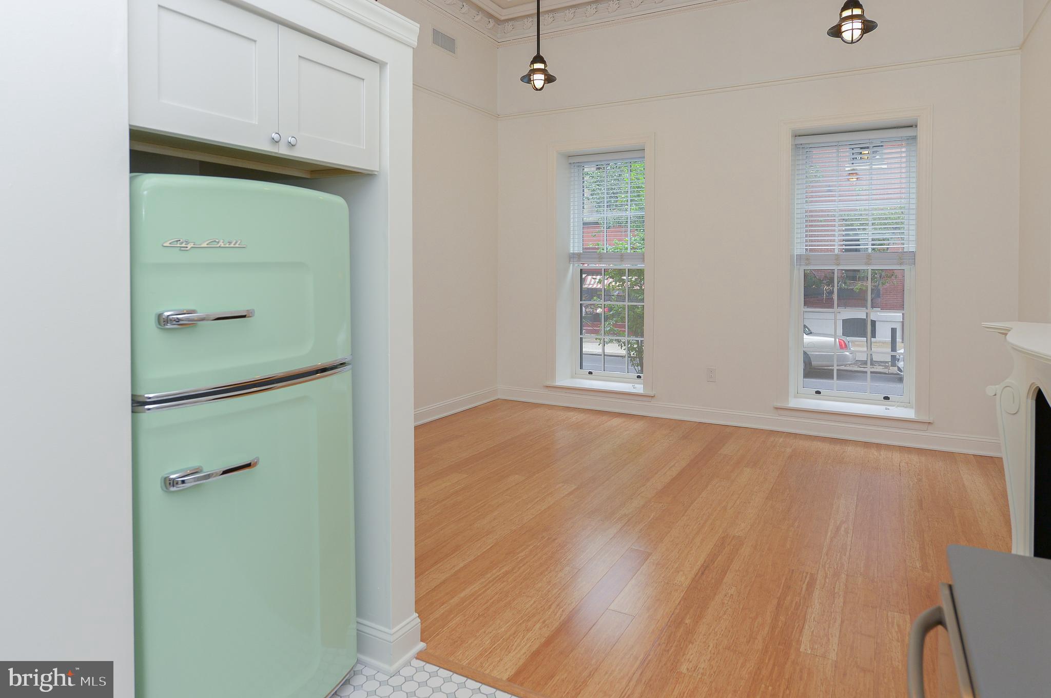 an empty room with windows and closet