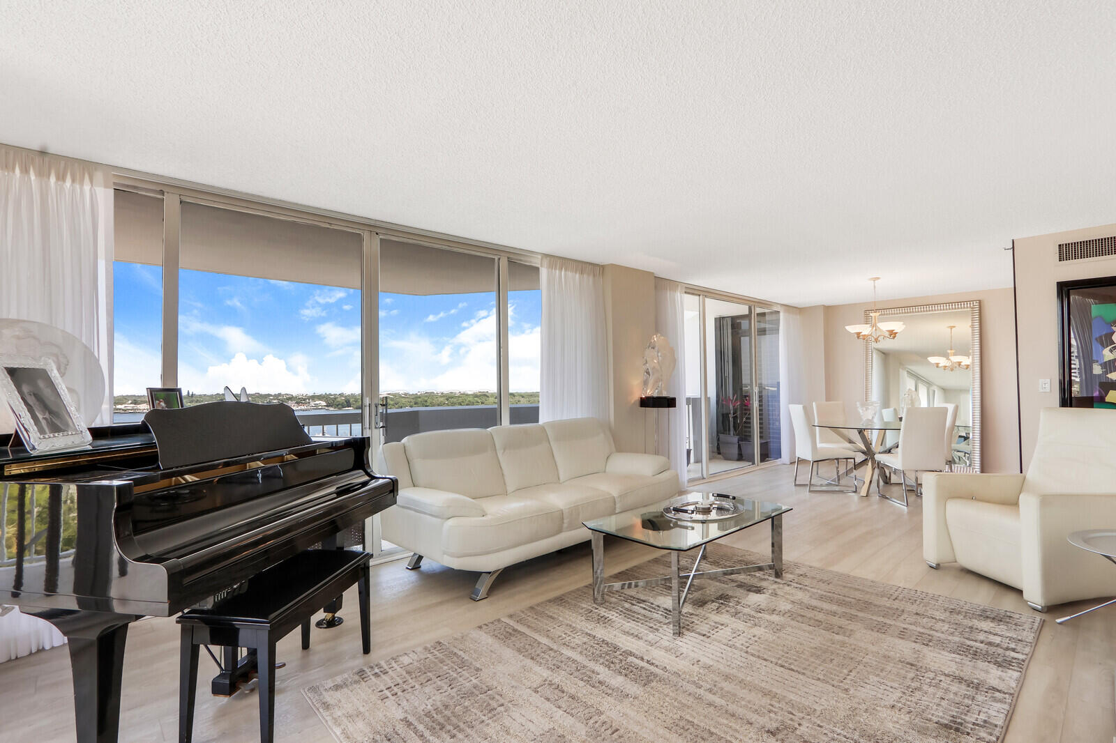 a living room with furniture and a piano