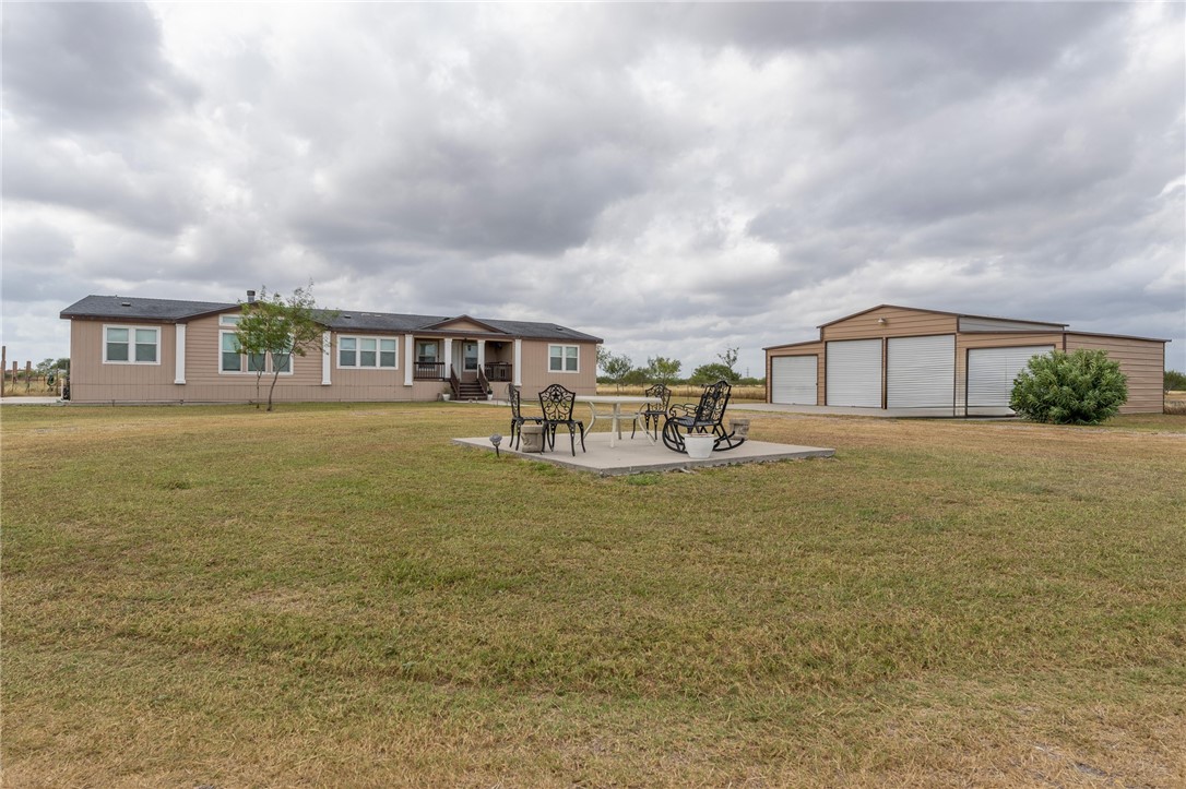 a front view of house with yard and lake