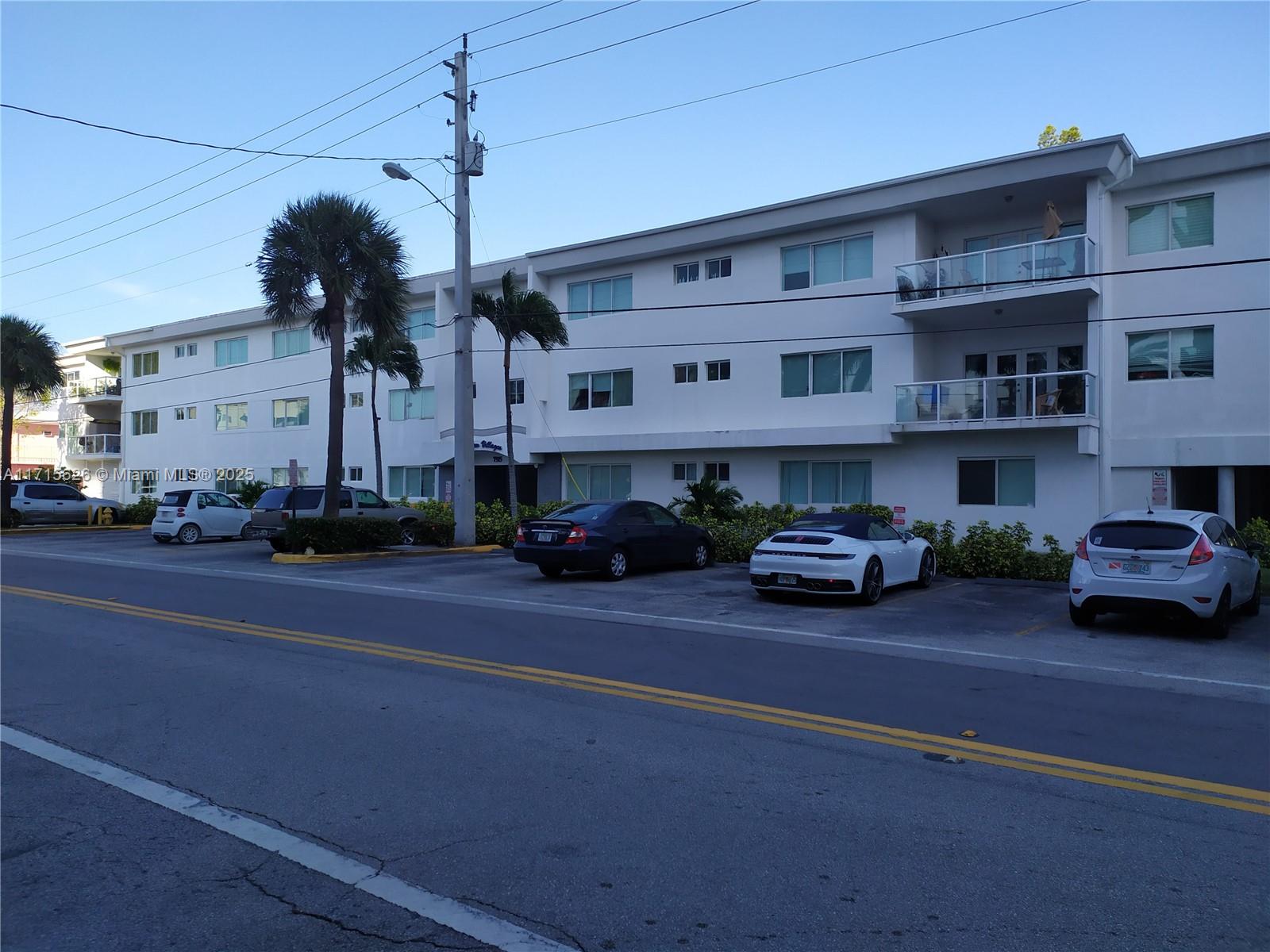 a view of a street that has couple of cars parked on the road