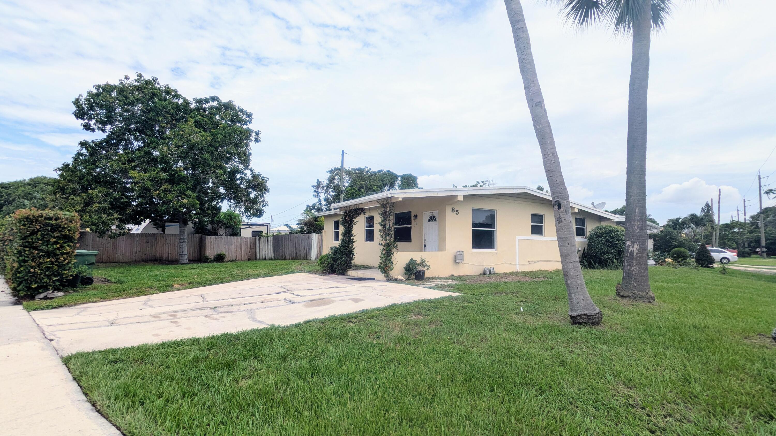 a house with palm tree in front of it