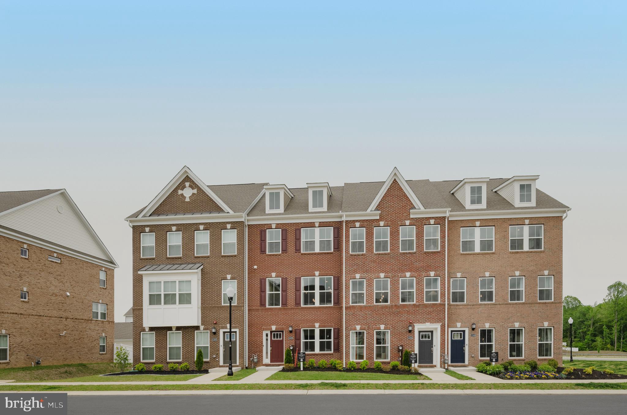 a front view of a residential apartment building with a yard