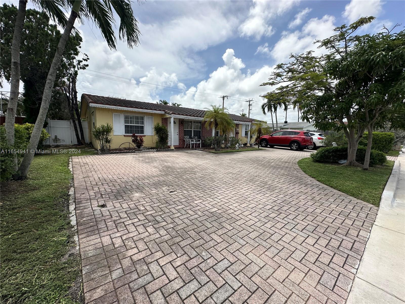 a view of a brick house with a yard