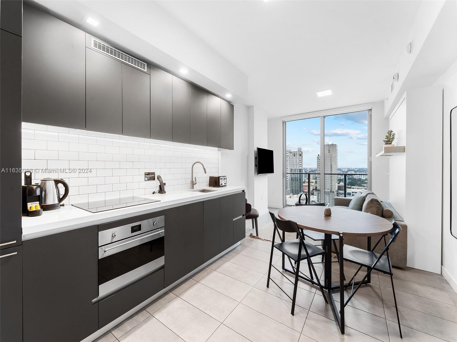 a large kitchen with a table and chairs