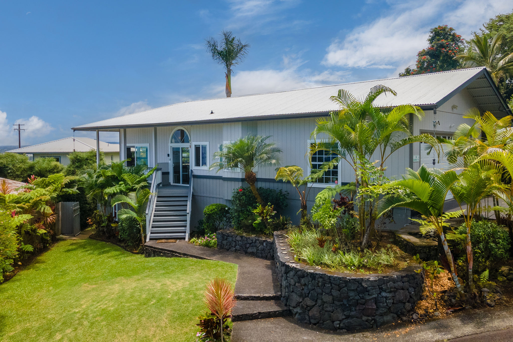 a view of a house with a flower garden