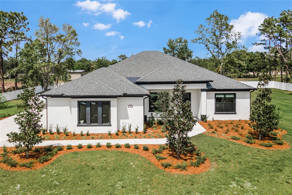 a front view of a house with a yard