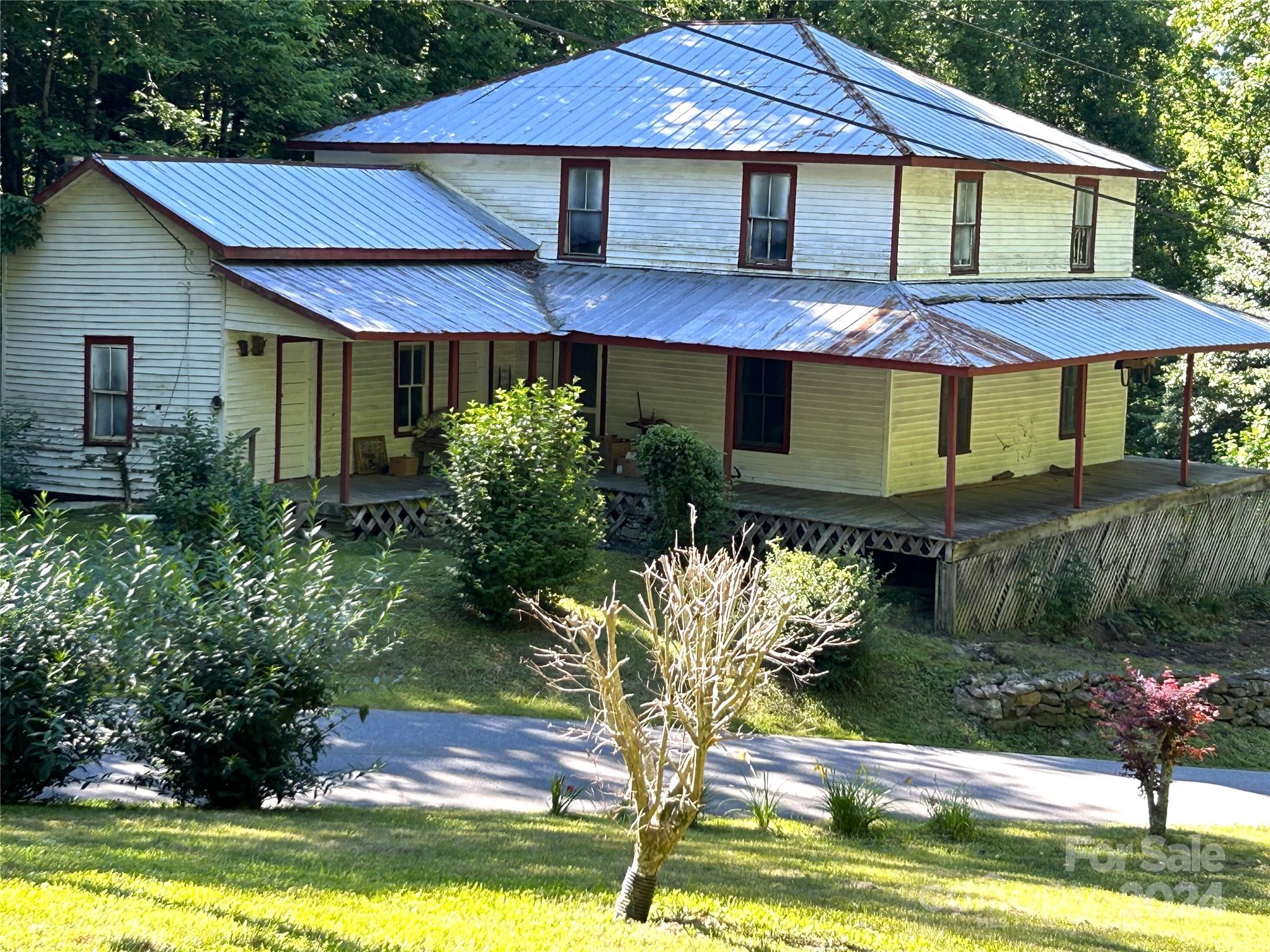 a front view of a house with a yard and porch