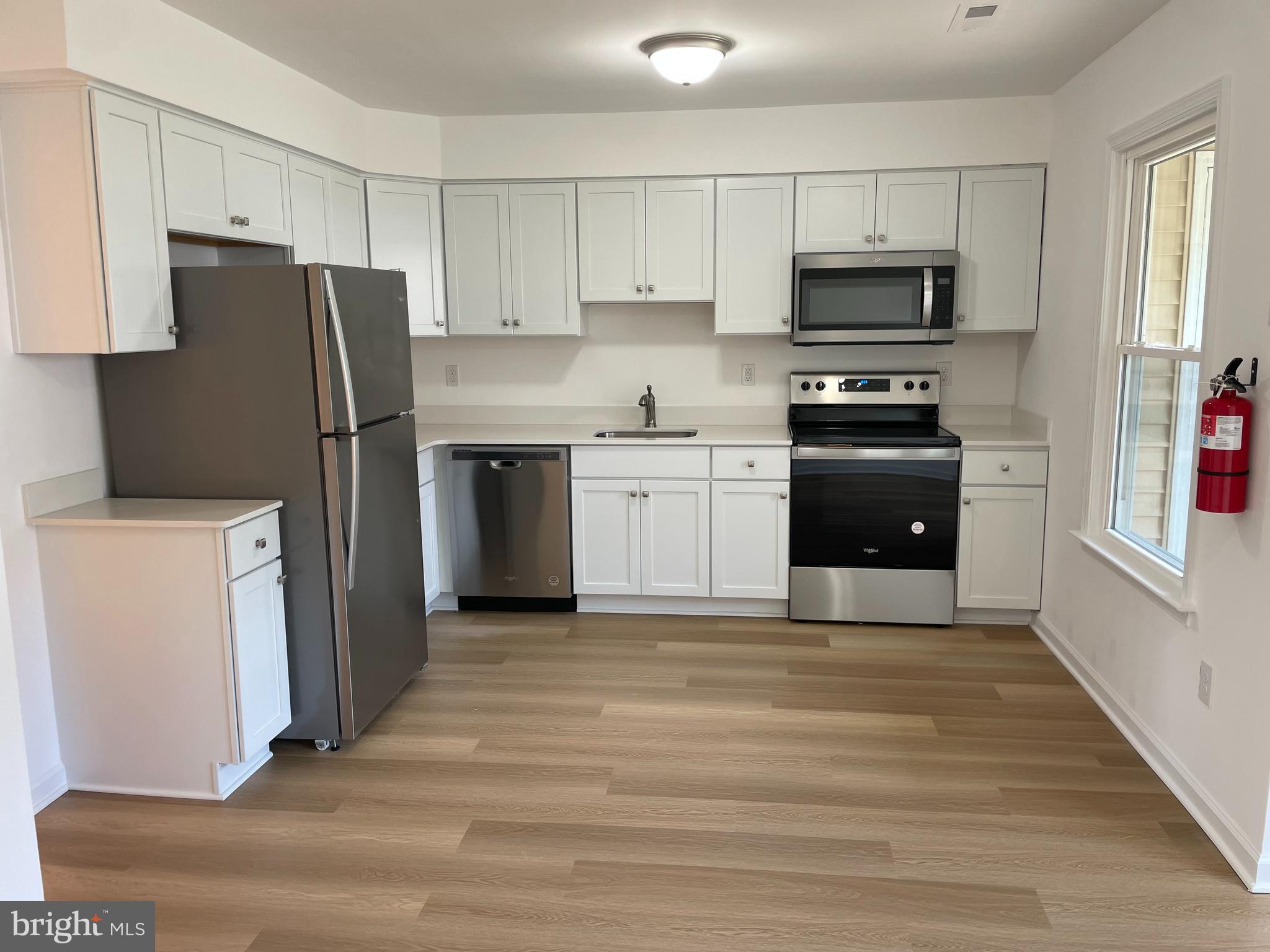 a kitchen with a refrigerator stove and microwave