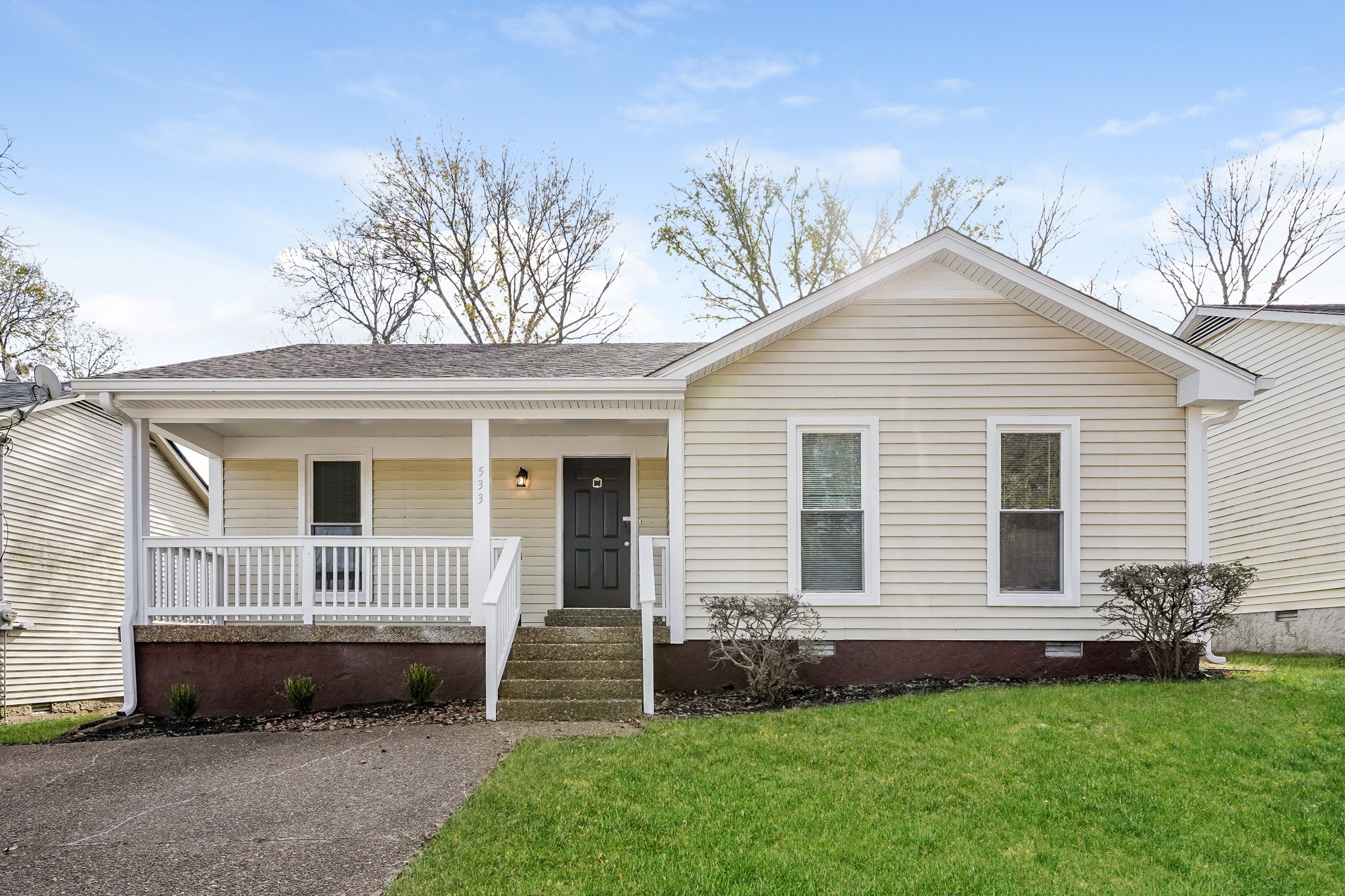 a front view of a house with a garden