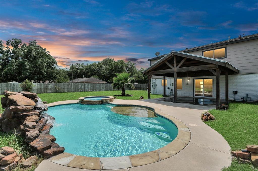 a view of a backyard with swimming pool