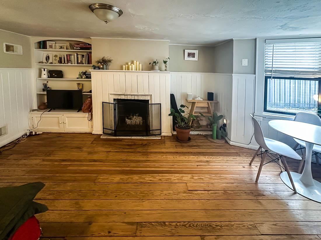 a living room with furniture and a fireplace