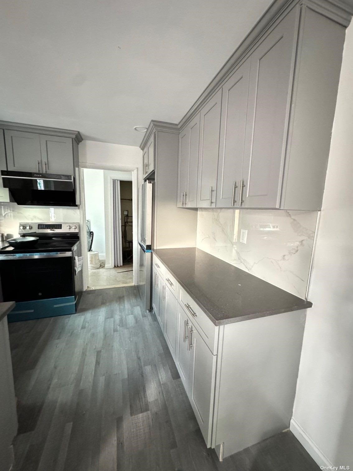 a kitchen with stainless steel appliances granite countertop a sink and a stove