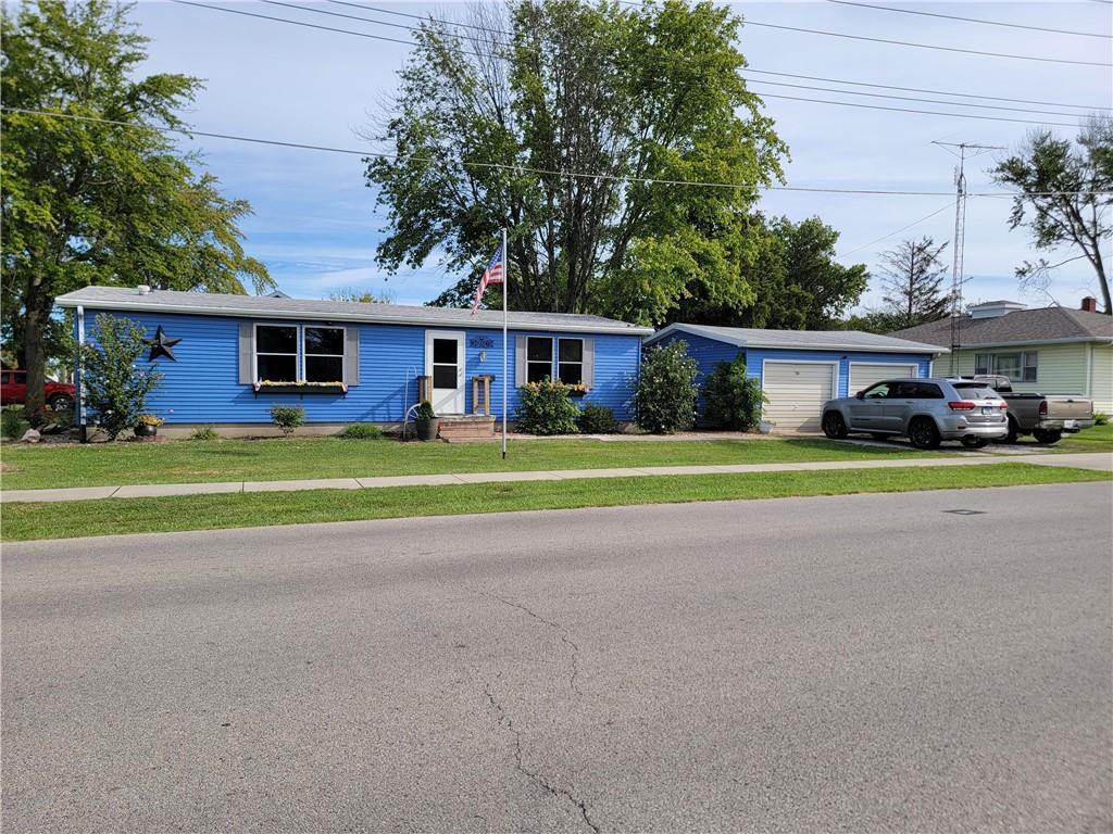 a view of house with outdoor space and parking